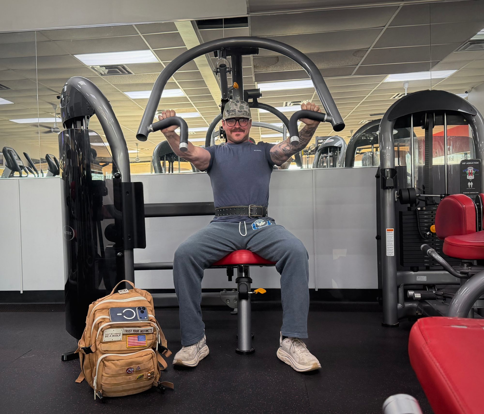 A smiling member on the chest press machine